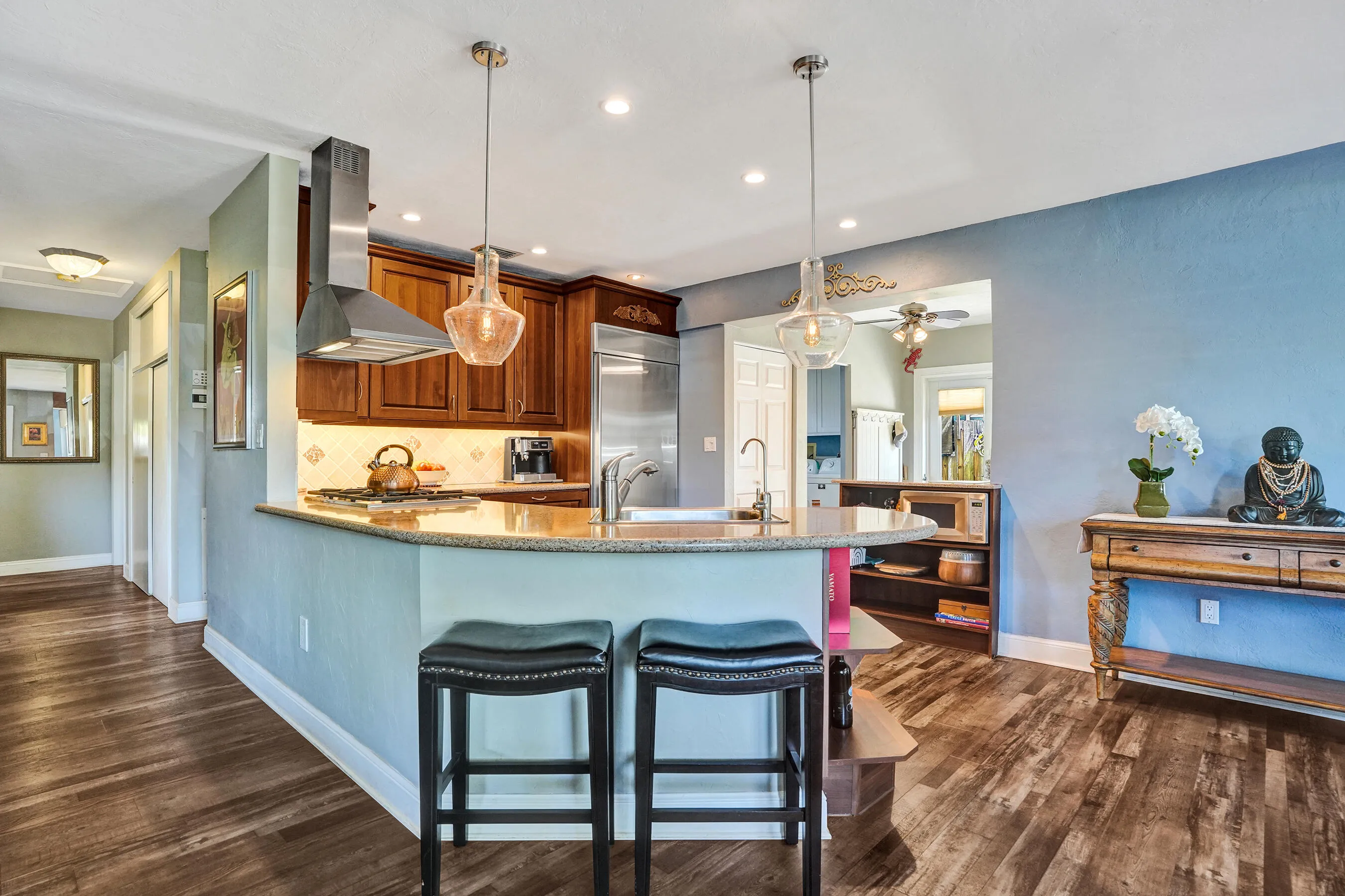 NKBA-designed chef's kitchen featuring ARAN Italian cabinetry, Silestone quartz countertops from Spain, KitchenAid Professional Series stainless appliances, natural gas cooktop, Bosch paneled dishwasher, walk-in pantry, and spacious eat-in peninsula.