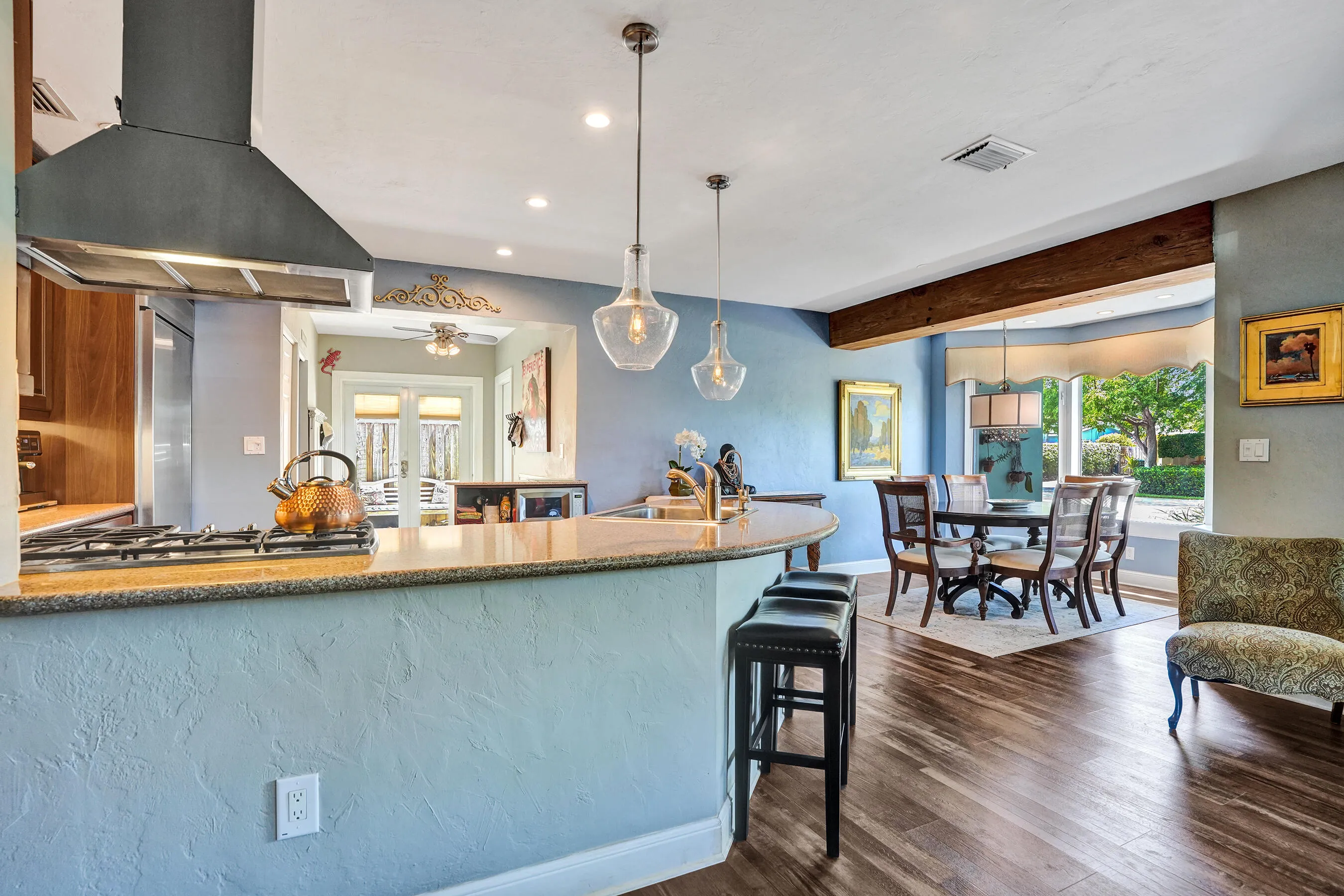 NKBA-designed chef's kitchen featuring ARAN Italian cabinetry, Silestone quartz countertops from Spain, KitchenAid Professional Series stainless appliances, natural gas cooktop, Bosch paneled dishwasher, walk-in pantry, and spacious eat-in peninsula.