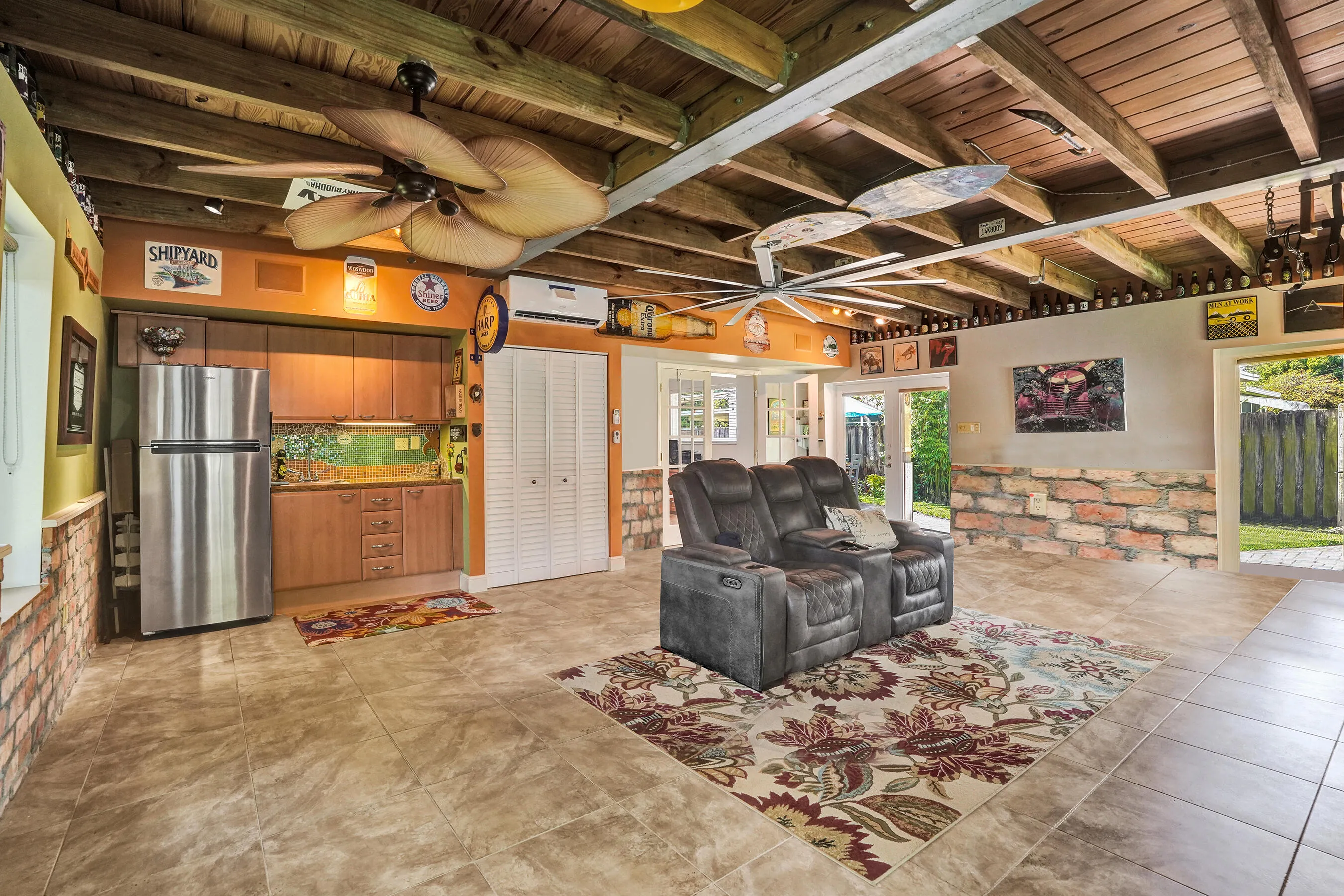Extraordinary bonus room with tongue-and-groove stained wood ceiling, Chicago brick accents, wet kitchenette, ARAN Italian cabinetry, granite countertops, TV bar, dedicated mini-split A/C, and endless possibilities for media, fitness, or guest accommodations.