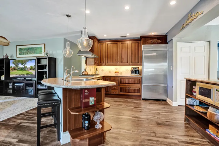 NKBA-designed chef's kitchen featuring ARAN Italian cabinetry, Silestone quartz countertops from Spain, KitchenAid Professional Series stainless appliances, natural gas cooktop, Bosch paneled dishwasher, walk-in pantry, and spacious eat-in peninsula.