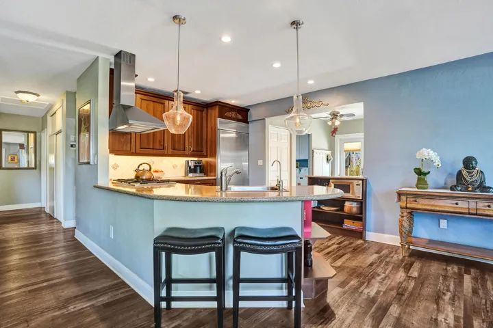 NKBA-designed chef's kitchen featuring ARAN Italian cabinetry, Silestone quartz countertops from Spain, KitchenAid Professional Series stainless appliances, natural gas cooktop, Bosch paneled dishwasher, walk-in pantry, and spacious eat-in peninsula.