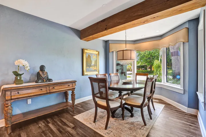 Open dining area adjacent to the chef's kitchen with bay window seating, ideal for everyday living and entertaining.