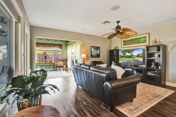Warm, inviting living space showcasing hand-plastered textured walls, Craftsman-style millwork, luxury vinyl plank flooring, and an open-concept design.