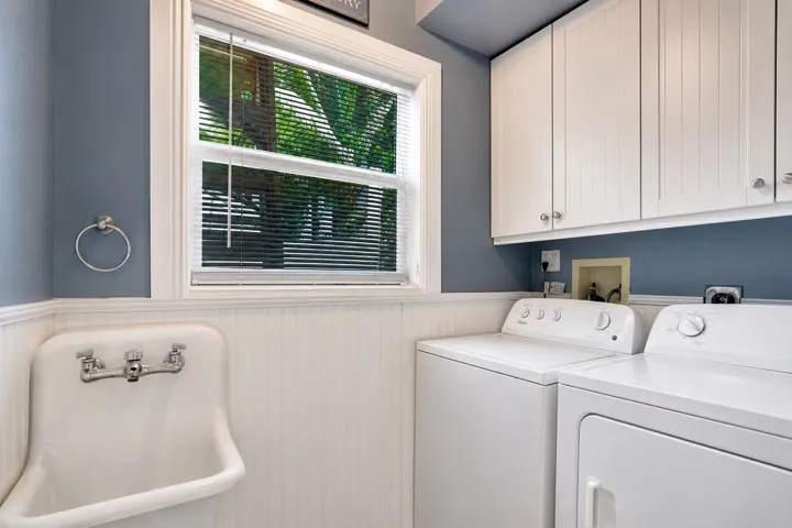 Convenient interior laundry room with Vintage utility sink, garage access, and adjacent mudroom.