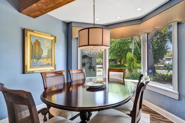 Open dining area adjacent to the chef's kitchen with bay window seating, ideal for everyday living and entertaining.