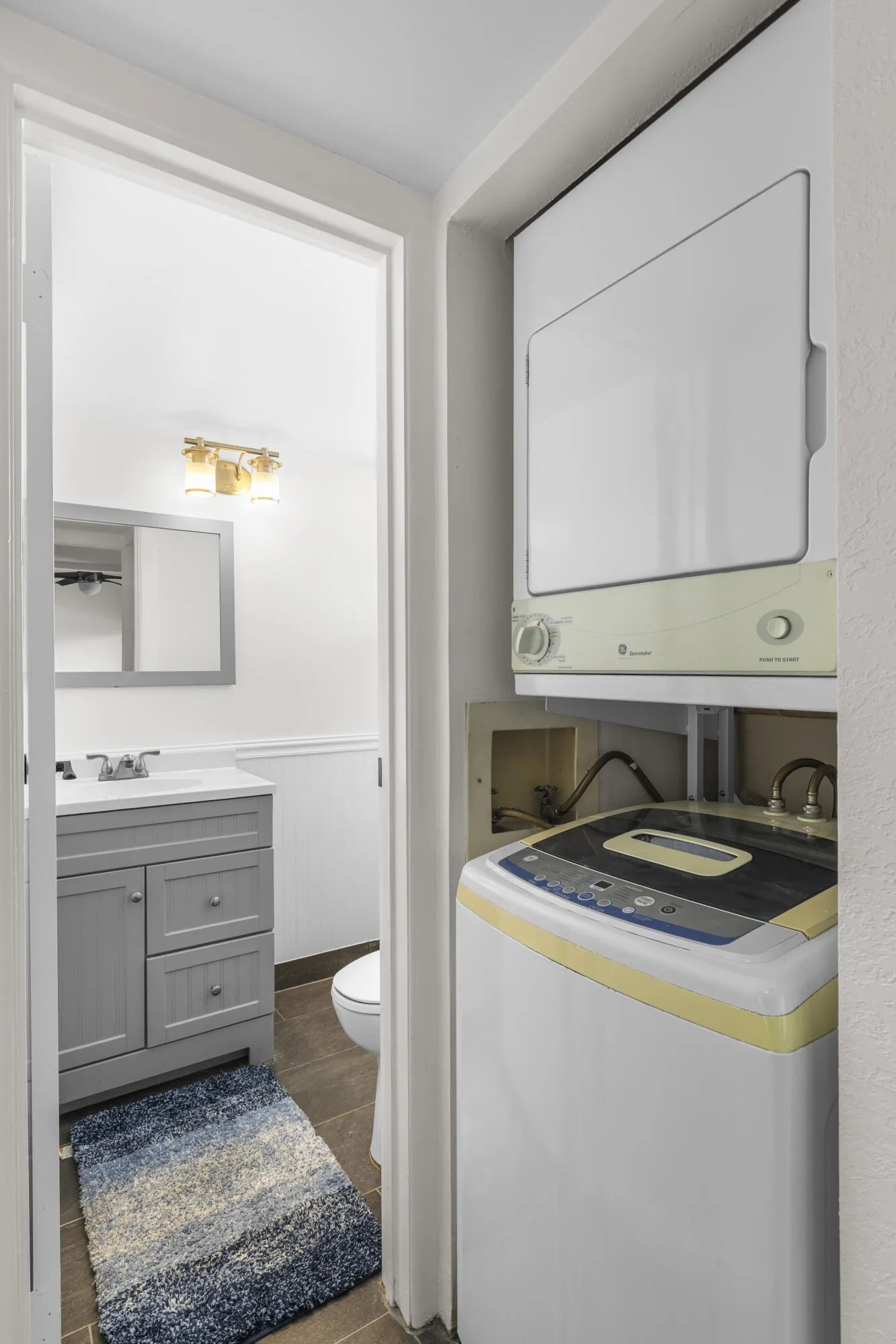 Washer and dryer featured as one enters the remodeled 1/2 bathroom