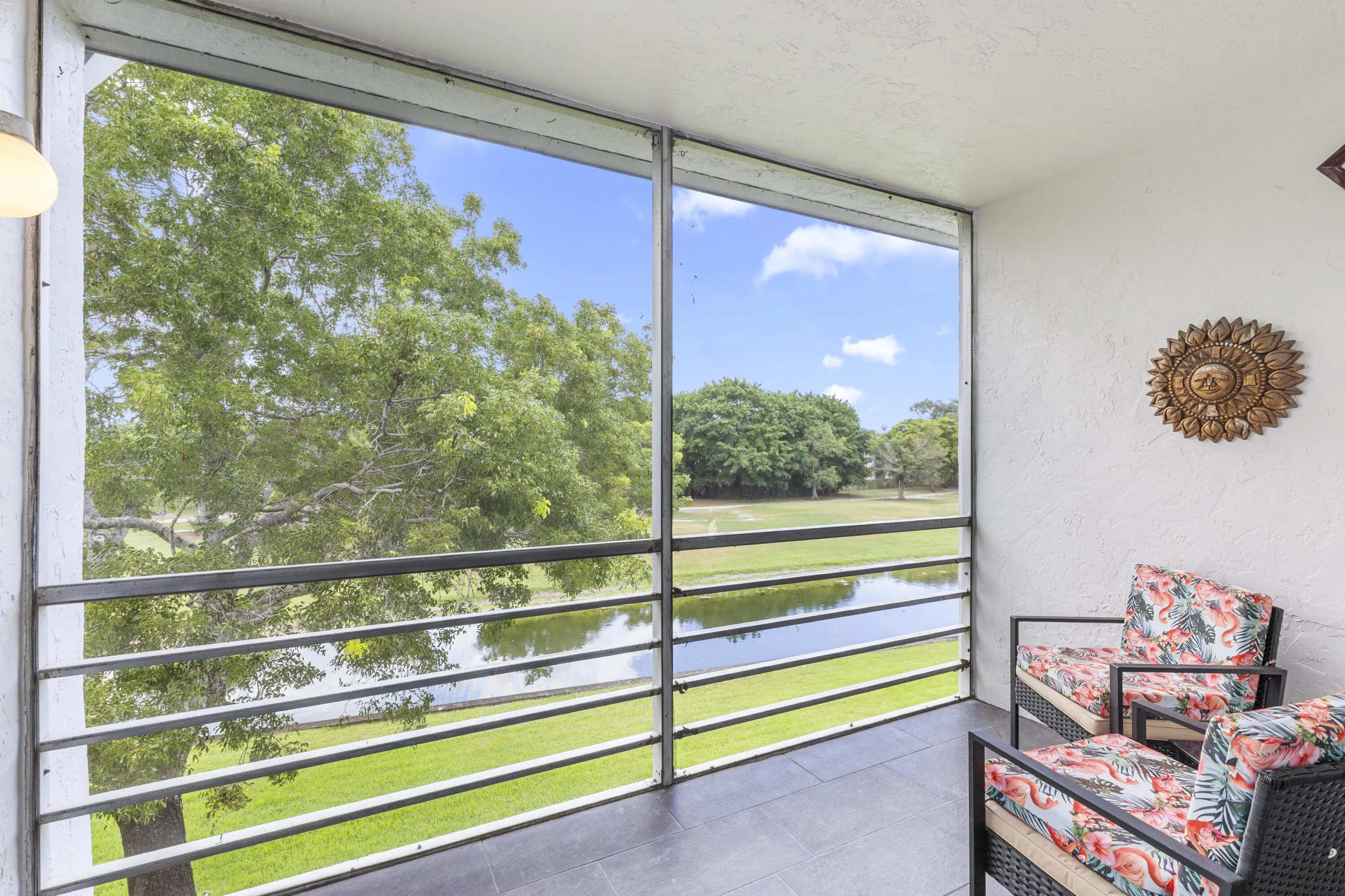 Incredible water and golf views from covered screened balcony