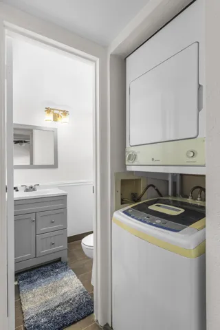 Washer and dryer featured as one enters the remodeled 1/2 bathroom