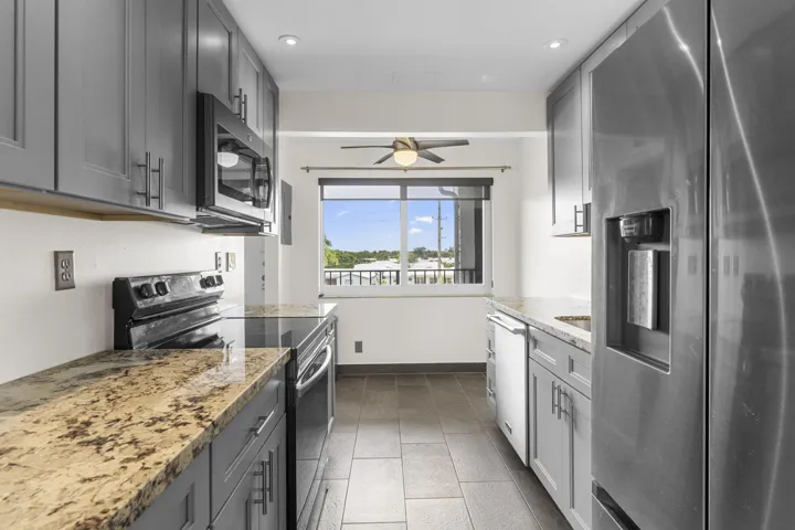 New kitchen w/ new cabinets, granite counters, eat-in kitchen dining with impact window