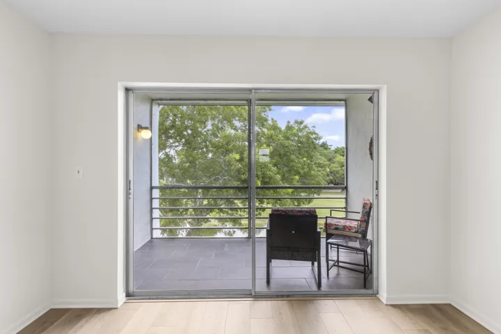 Primary bedroom slider to covered/screened balcny