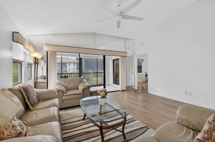 Expansive living area opens seamlessly to the screened balcony.