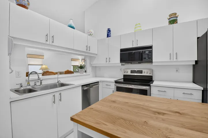 Abundant cabinetry, stainless appliances, & generous prep space.