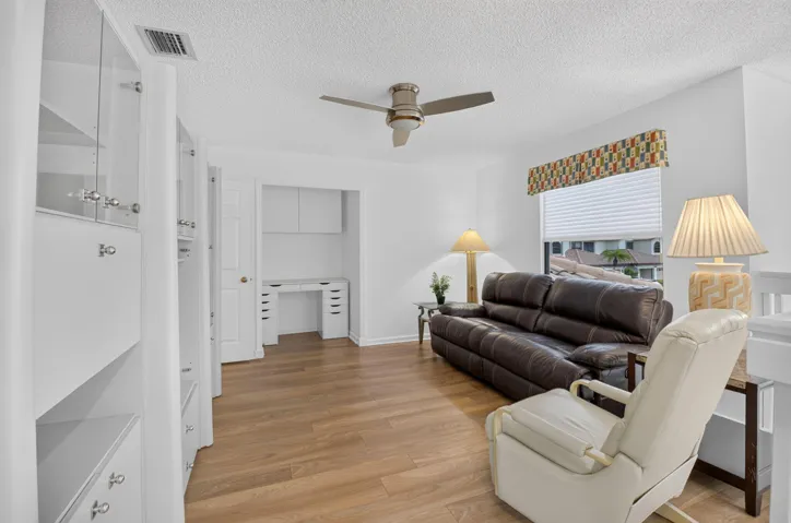 Versatile flex room with custom workspace & comfortable seating.