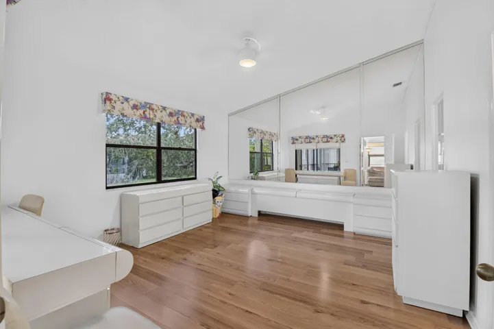 Mirrowed walls enhance space and natural light throughout.