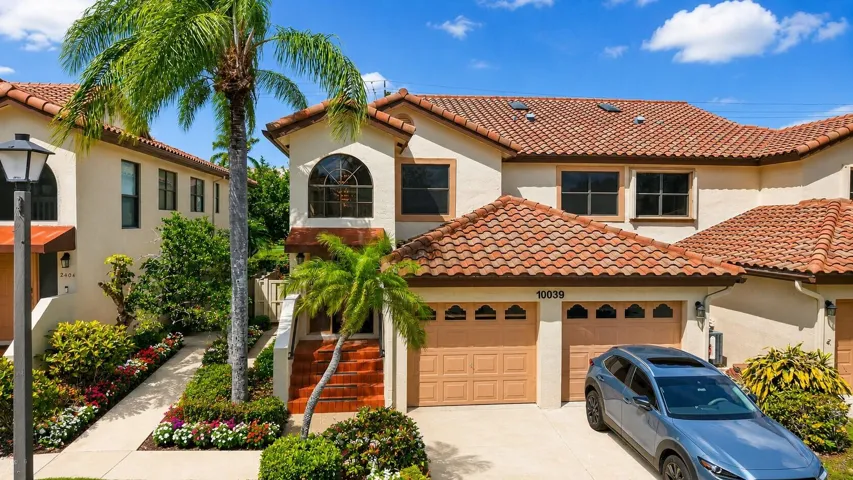 Lush landscaping, private entry, attached garage, & exceptional curb appeal.