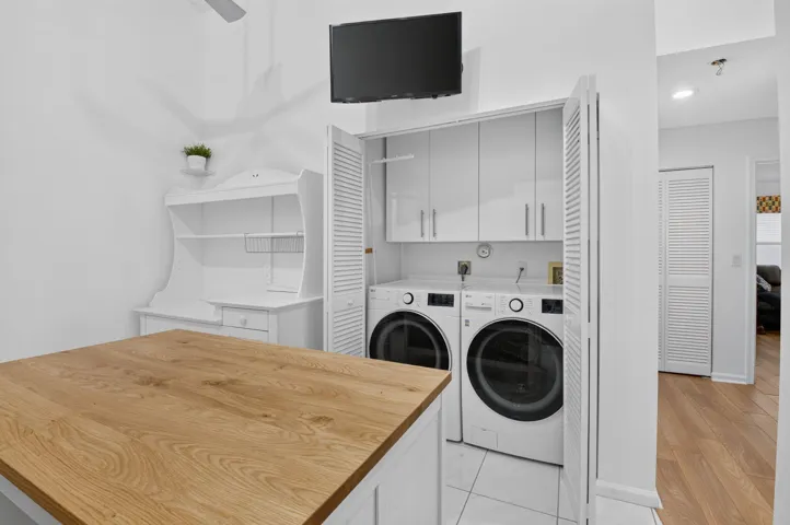 Full-size washer & dryer and overhead storage for everyday convenience.