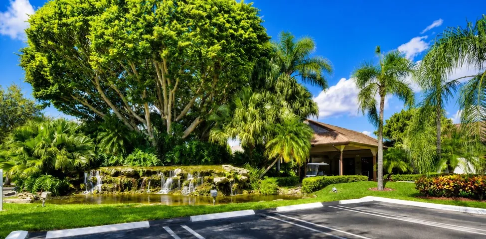 Lush landscaping and waterfalls create a warm resort-style welcome.