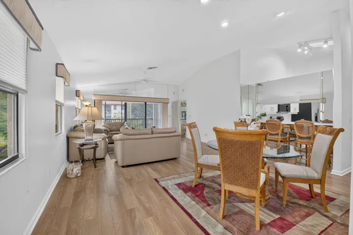Vaulted ceilings seamlessly connected living, dining, & kitchen areas.