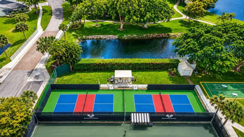 Dedicated pickleball courts overlooking serene lakes and lush tropical landscaping.