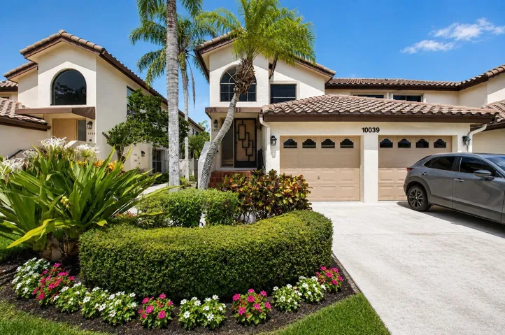 Attractive curb appeal with lush tropical landscaping