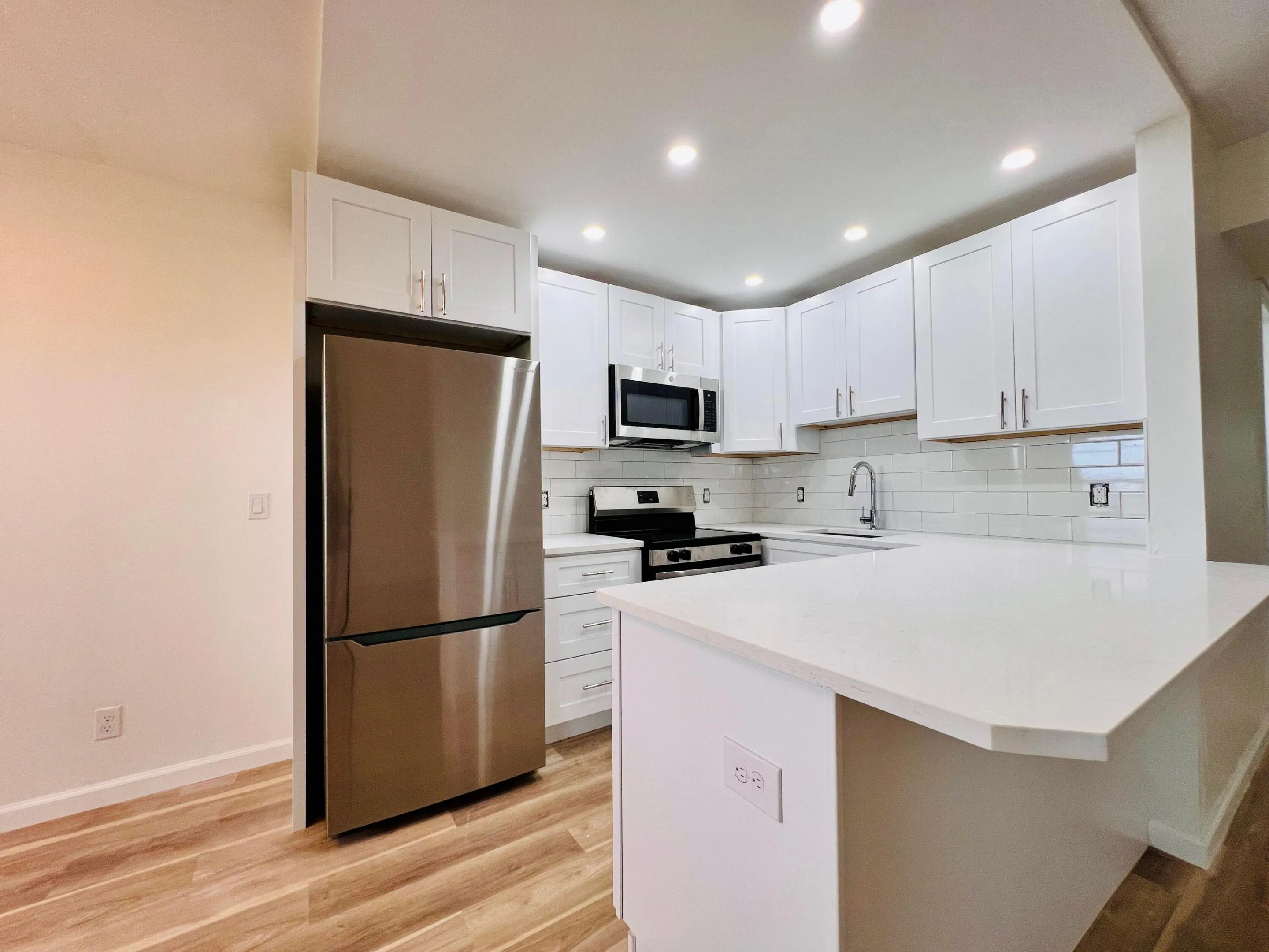 Brand NEW Kitchen - Never Used! White Shaker Style Cabinets, Stainless Appliances, Solid Surface Counters, Subway Tile Backsplash, and High Hat Lights