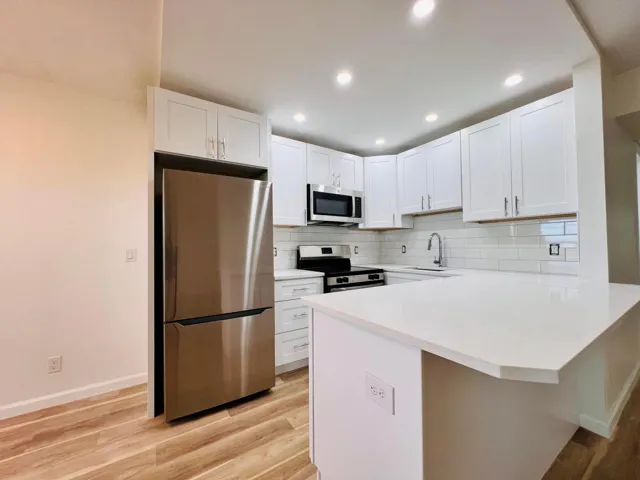 Brand NEW Kitchen - Never Used! White Shaker Style Cabinets, Stainless Appliances, Solid Surface Counters, Subway Tile Backsplash, and High Hat Lights