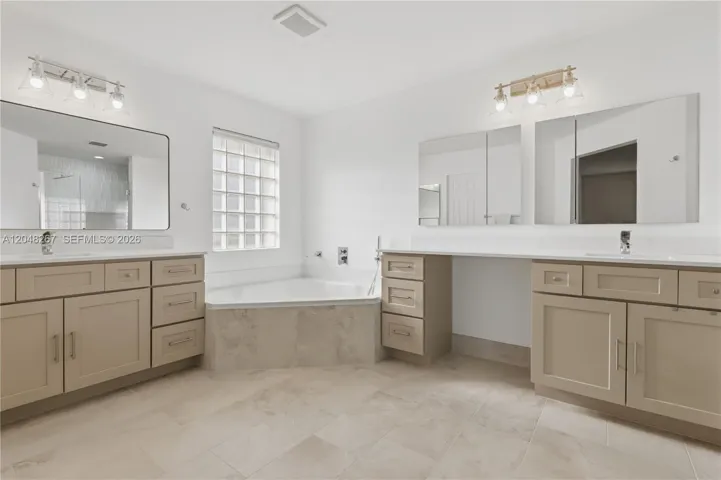 Main Bathroom with separate sinks.