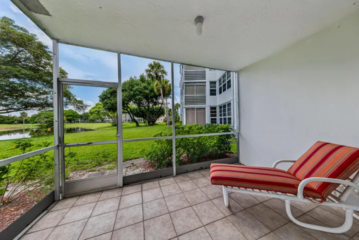 large balcony off primary bedroom, with door to the golf course