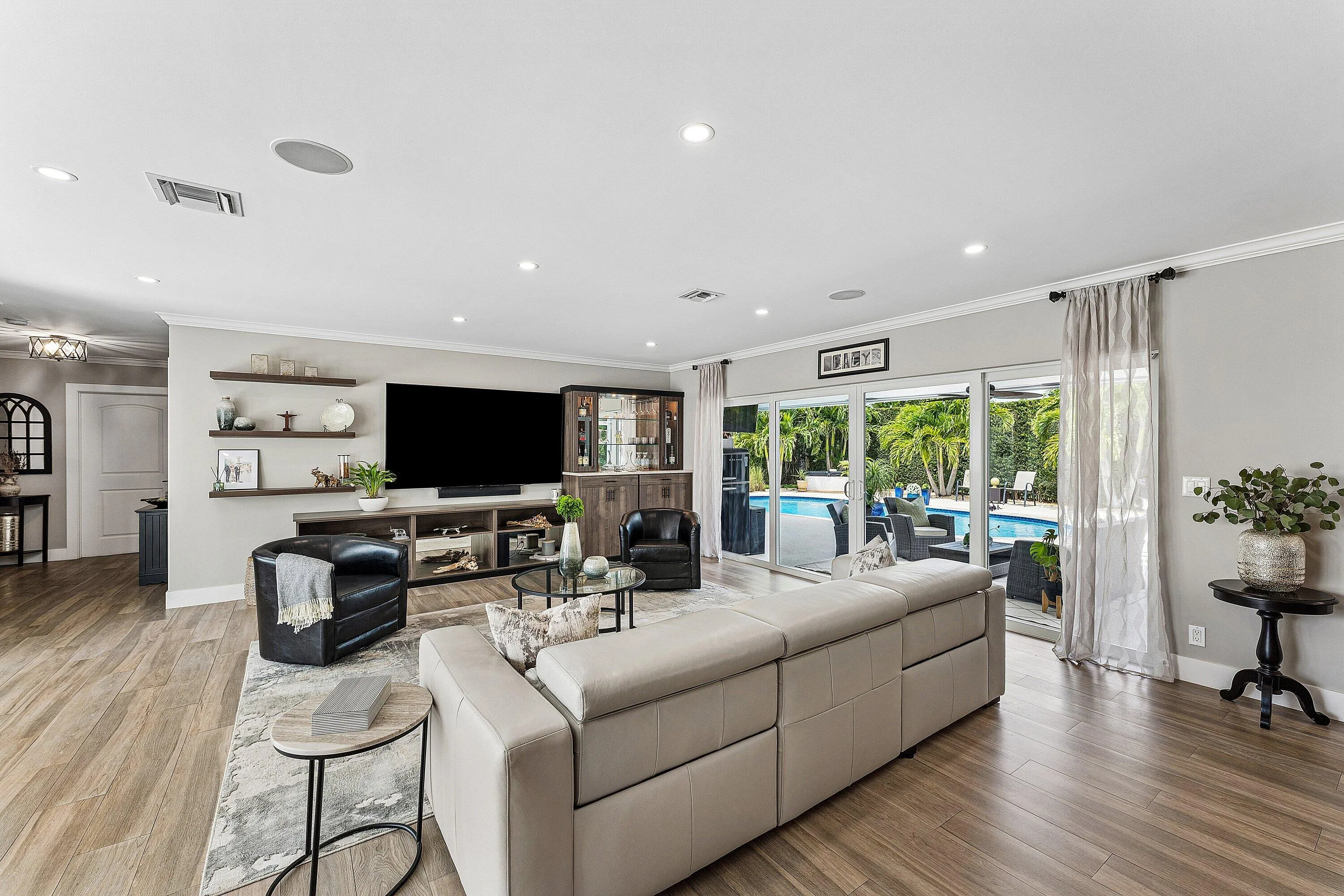 Custom Built-In Dry Bar & Sliding Glass Doors Provide Easy Access to the Patio & Pool