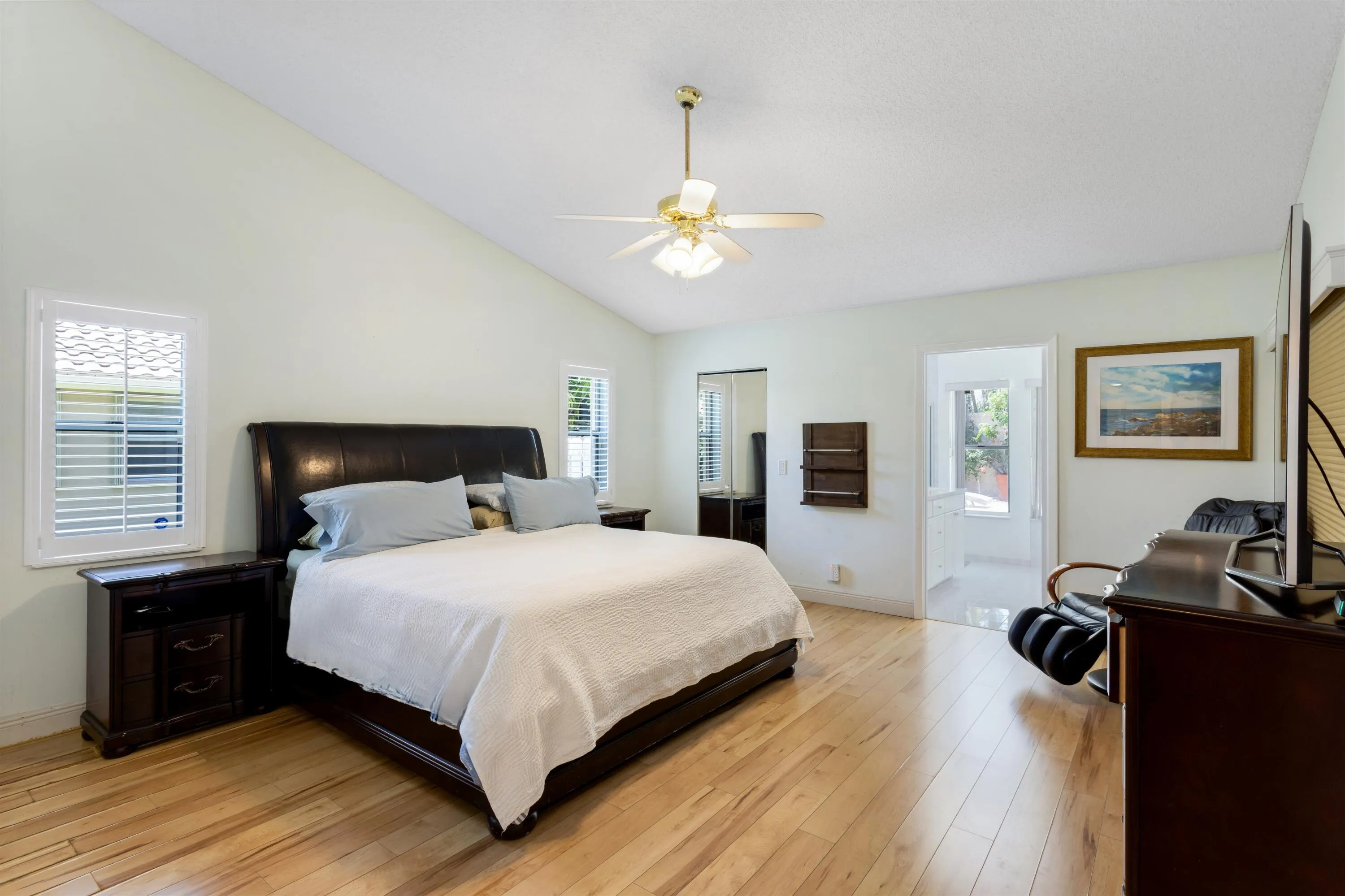 spacious primary suite with vaulted ceilings and two closets