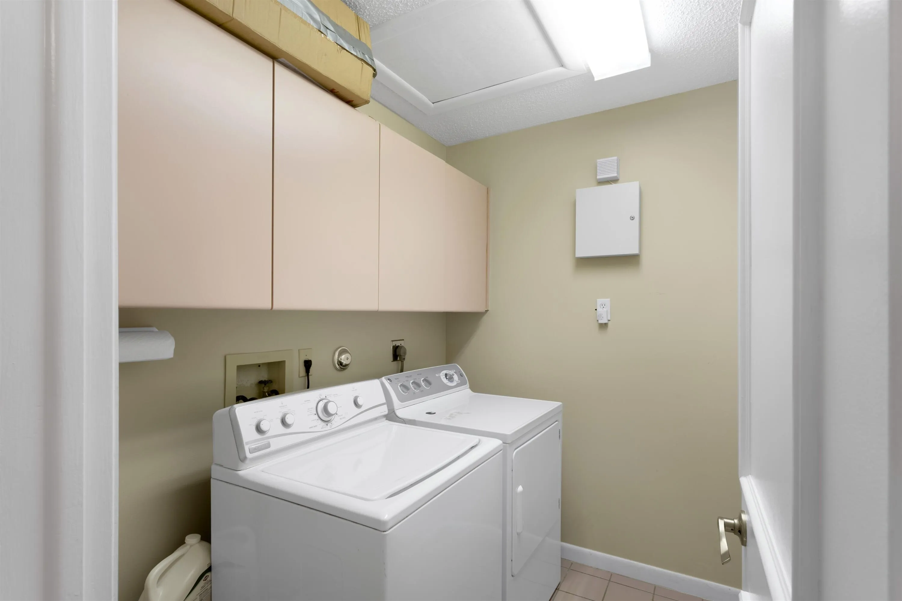 interior laundry room with cabinetry for storage