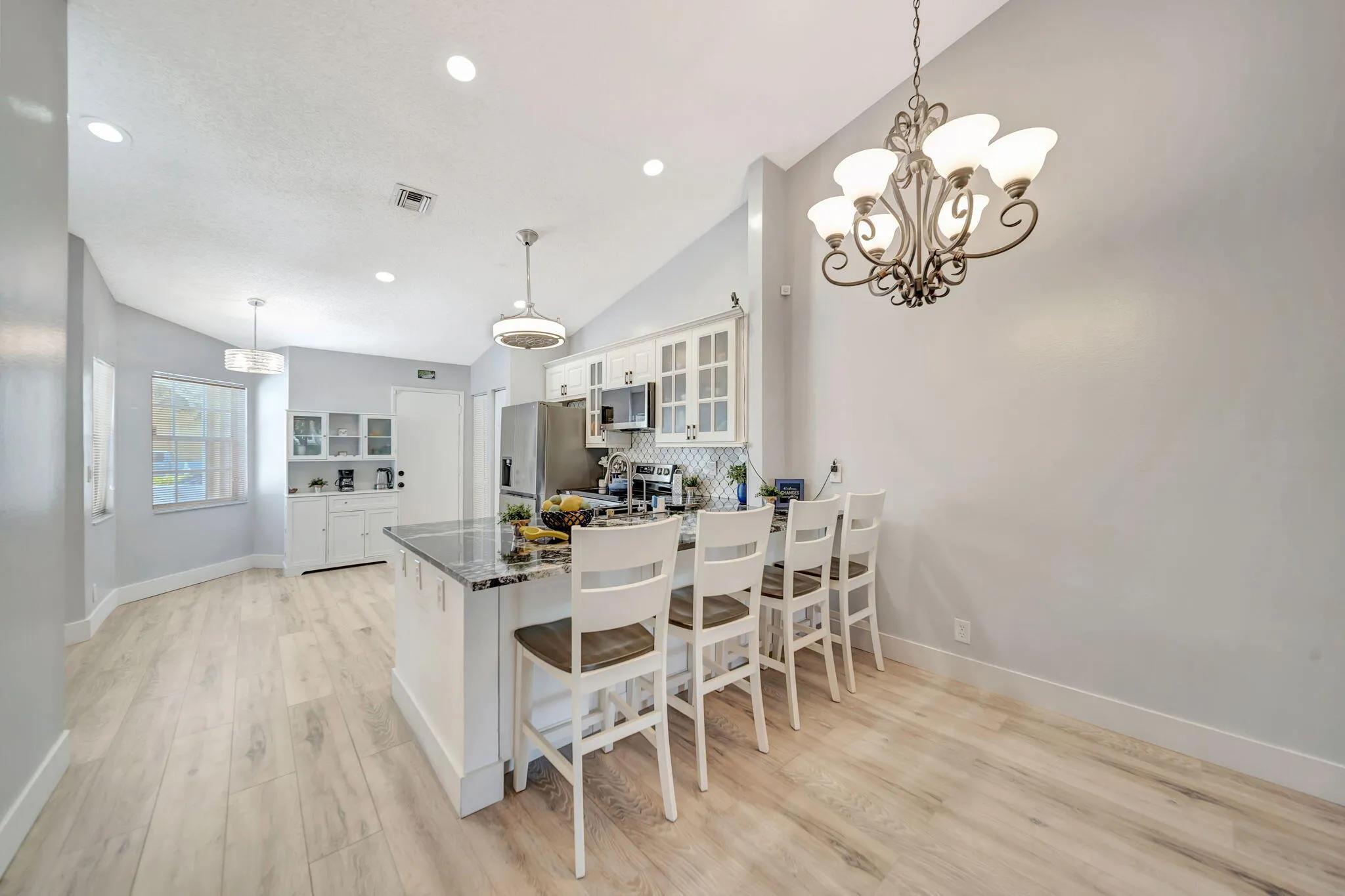 Open concept, breakfast bar with back cabinets for extra storage