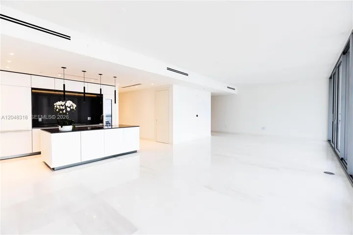 Spacious Living/Dining - Custom Kitchen - an open chef’s kitchen with custom Bulthaup cabinetry and top-of-the-line Gaggenau appliances is complemented by solid-core Bertolotto doors and imported Thassos marble flooring from Greece.