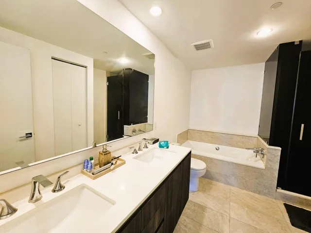 Dual vanity with polished chrome fixtures and an integrated rectangular sink