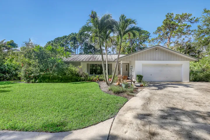 Palms and a two-car garage welcome you home every day.
