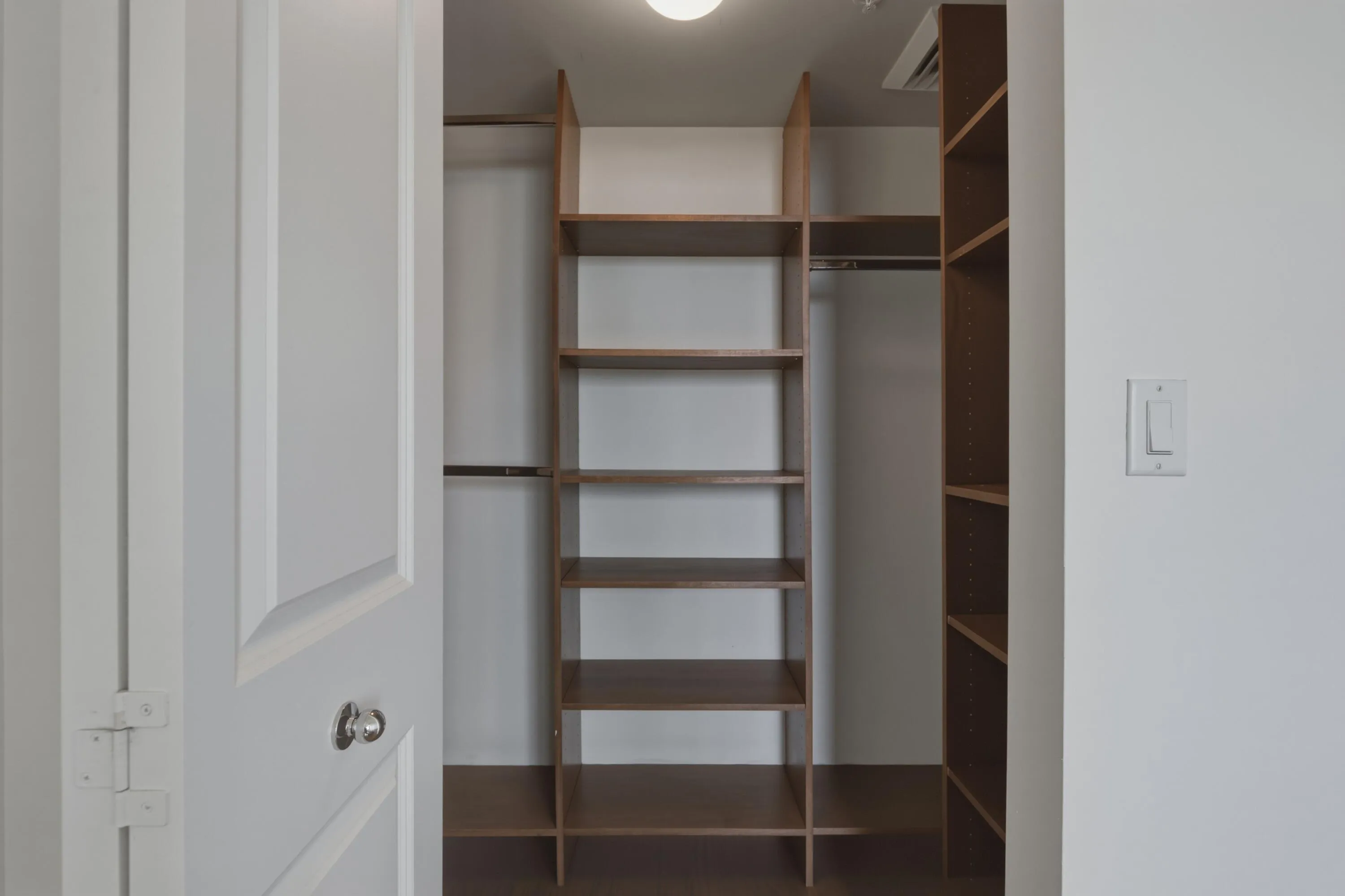 Primary Bedroom Walk-In Closet with custom cabinetry