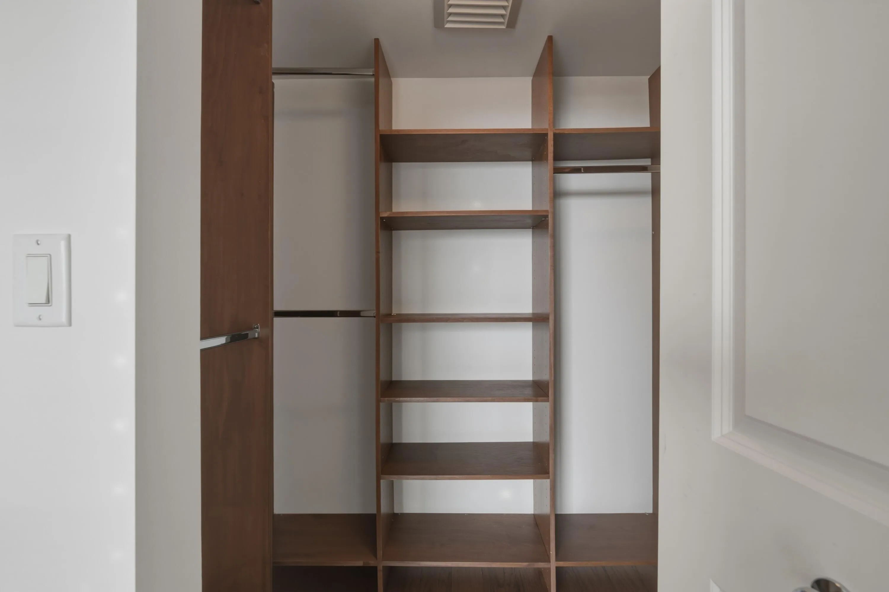 Guest Bedroom Walk-In Closet with custom cabinetry