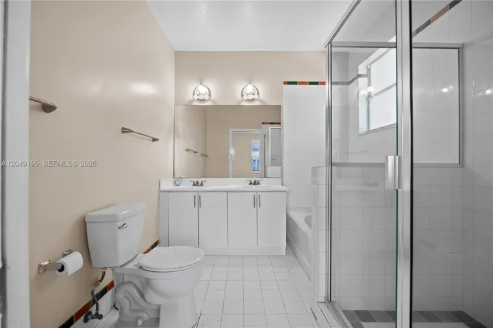 Master bathroom has standing shower and bathtub.