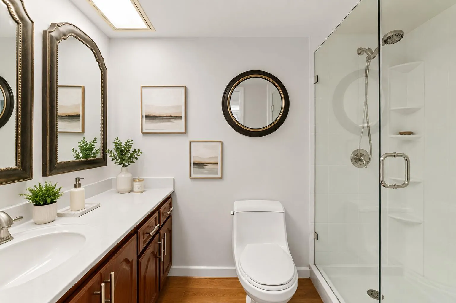 The bathroom features a renovated shower with a frameless glass door.