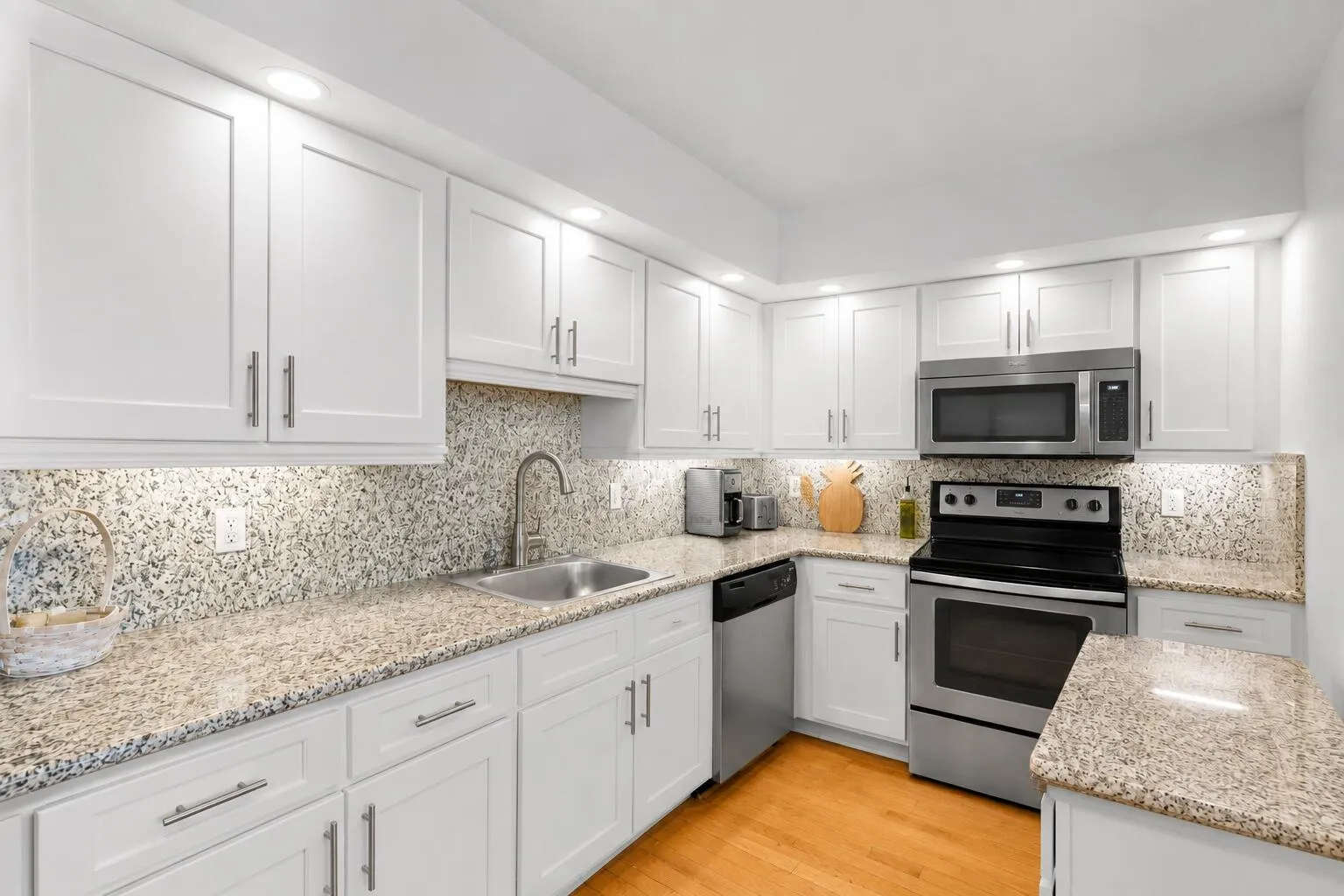Virtually modified kitchen with white cabinets showing the potential with a simple refacing of the cabinets.