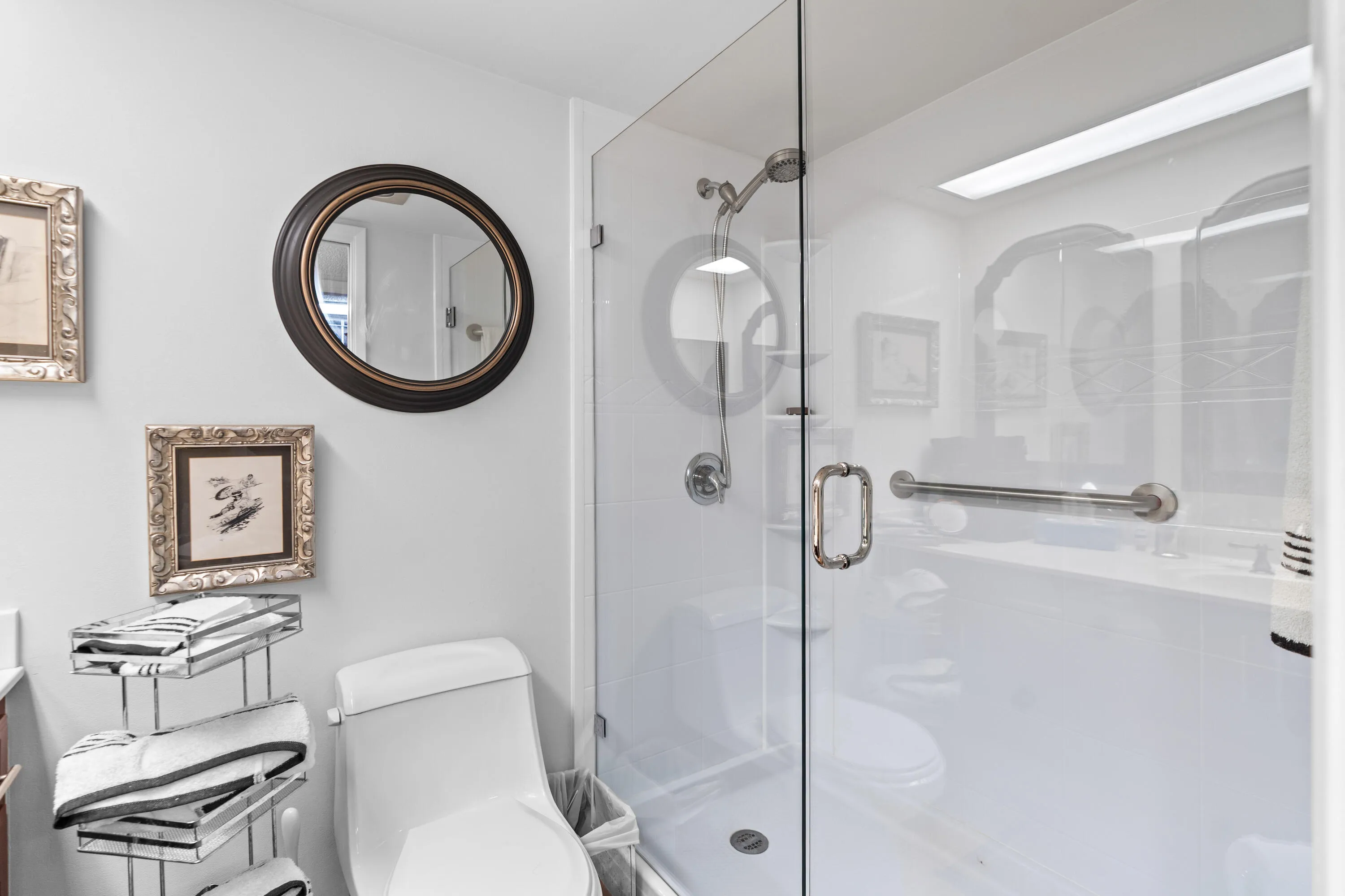 The ensuite bath features a sleek modern frameless glass shower, blending timeless style with everyday comfort.