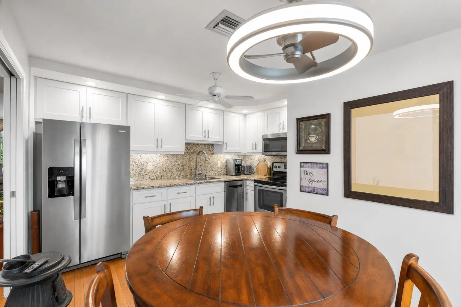 VVirtually modified kitchen with white cabinets showing the potential with a simple refacing of the cabinets.