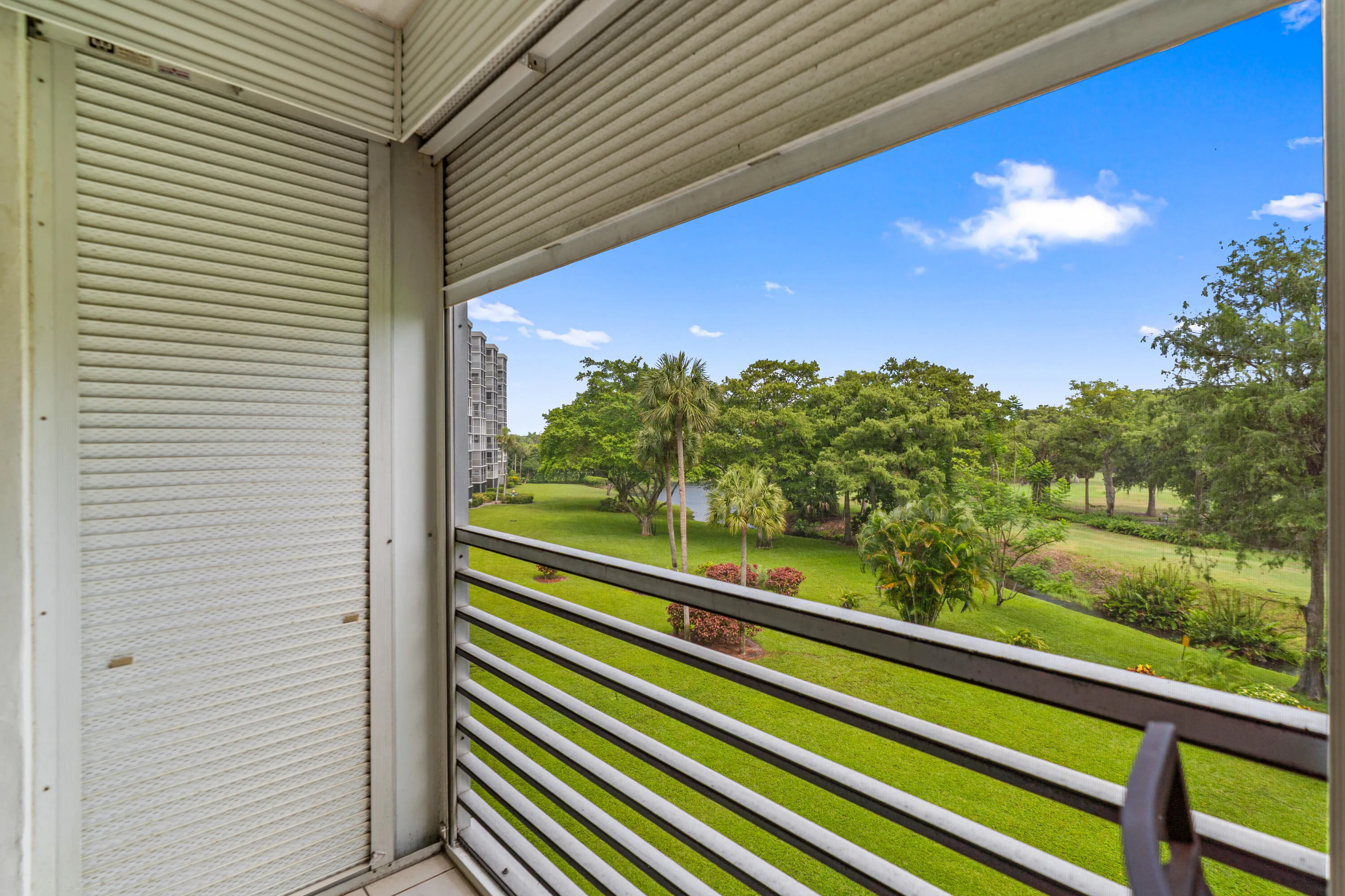 One of this home's most inviting features is the spacious screened balcony overlooking lush golf course greens and mature trees.