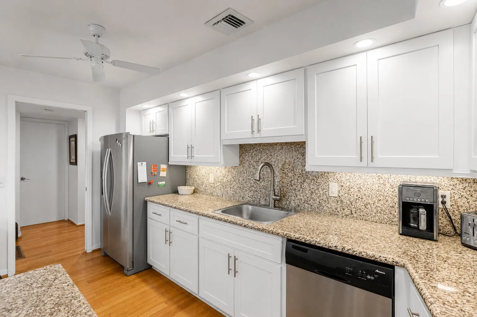 Virtually modified kitchen with white cabinets showing the potential with a simple refacing of the cabinets.