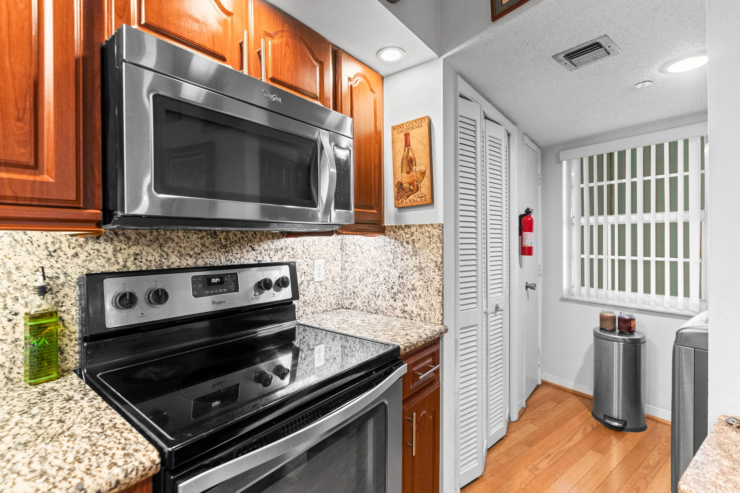 The kitchen features granite countertops, newer stainless steel appliances and a pantry.