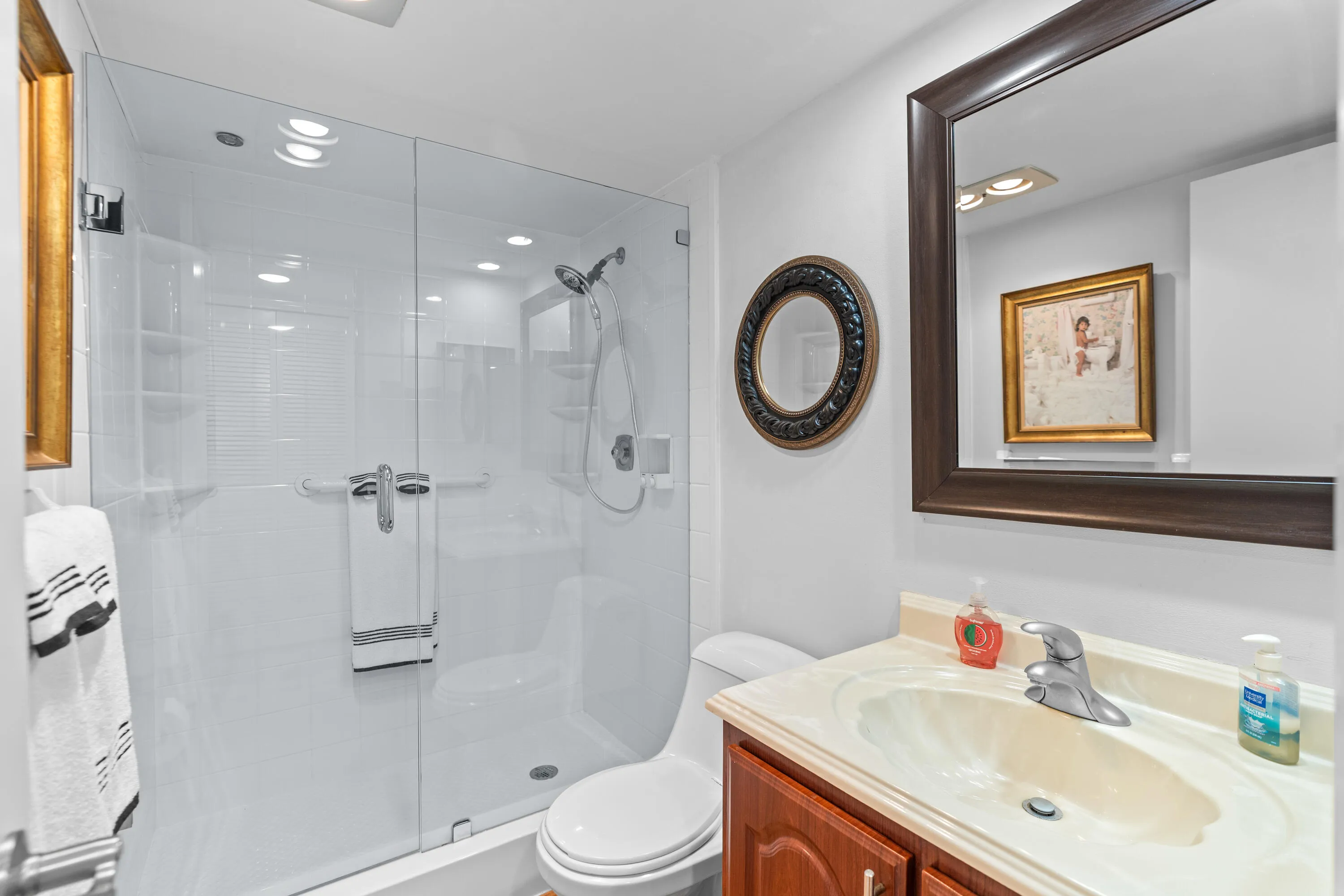 The guest bedroom includes a beautifully renovated ensuite bathroom with a modern walk-in shower, offering both privacy and convenience.