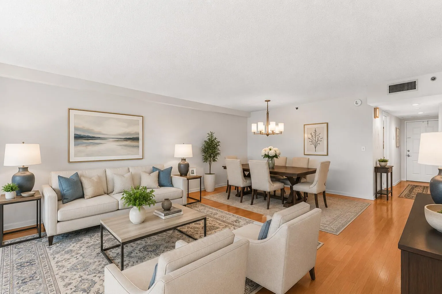 Virtually Staged expansive living and dining area showcases rich cherry hardwood flooring and an open, inviting layout that flows seamlessly to the screened balcony overlooking the golf course.