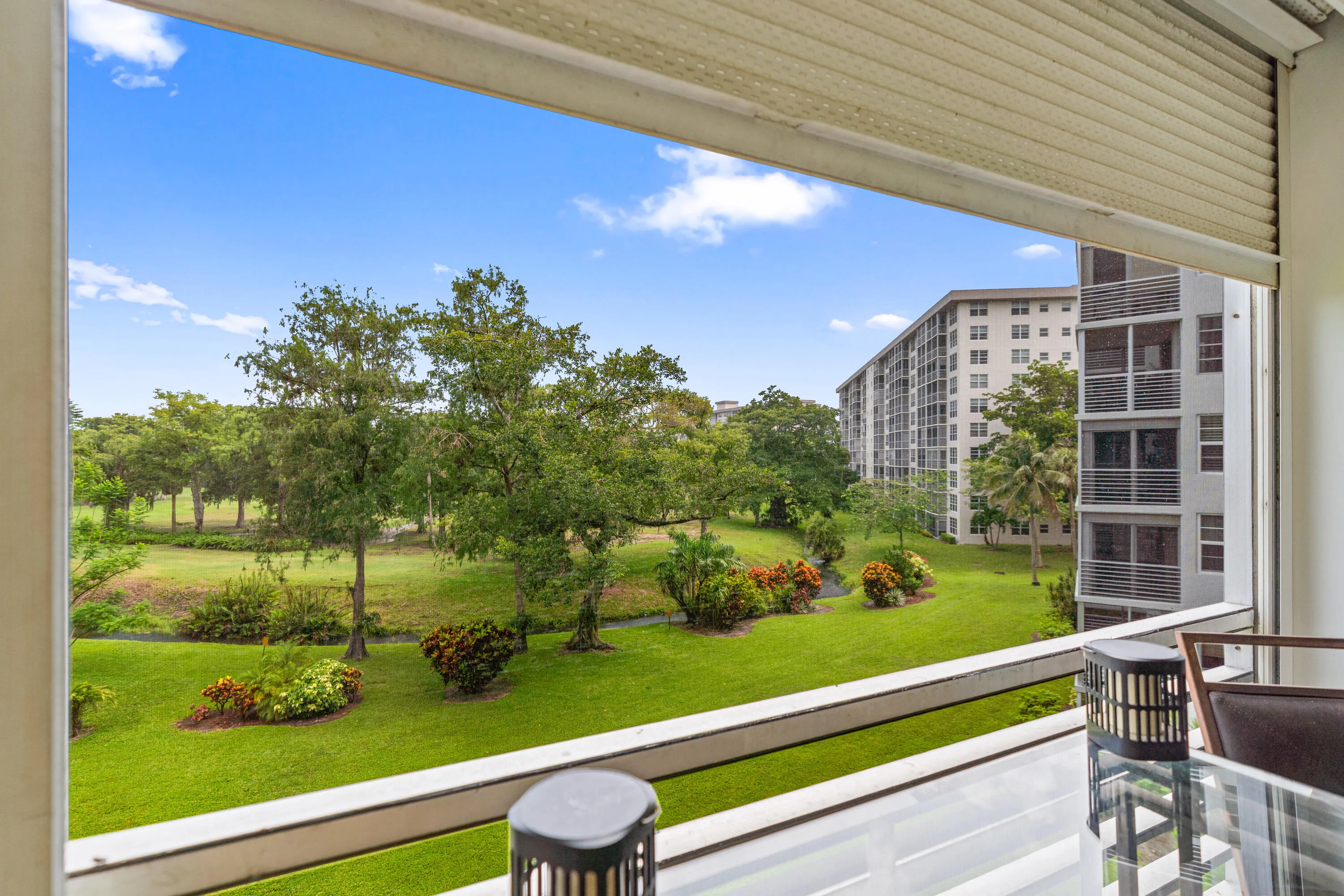 Step outside to your screened balcony and enjoy panoramic views of the golf course and mature tropical landscaping.