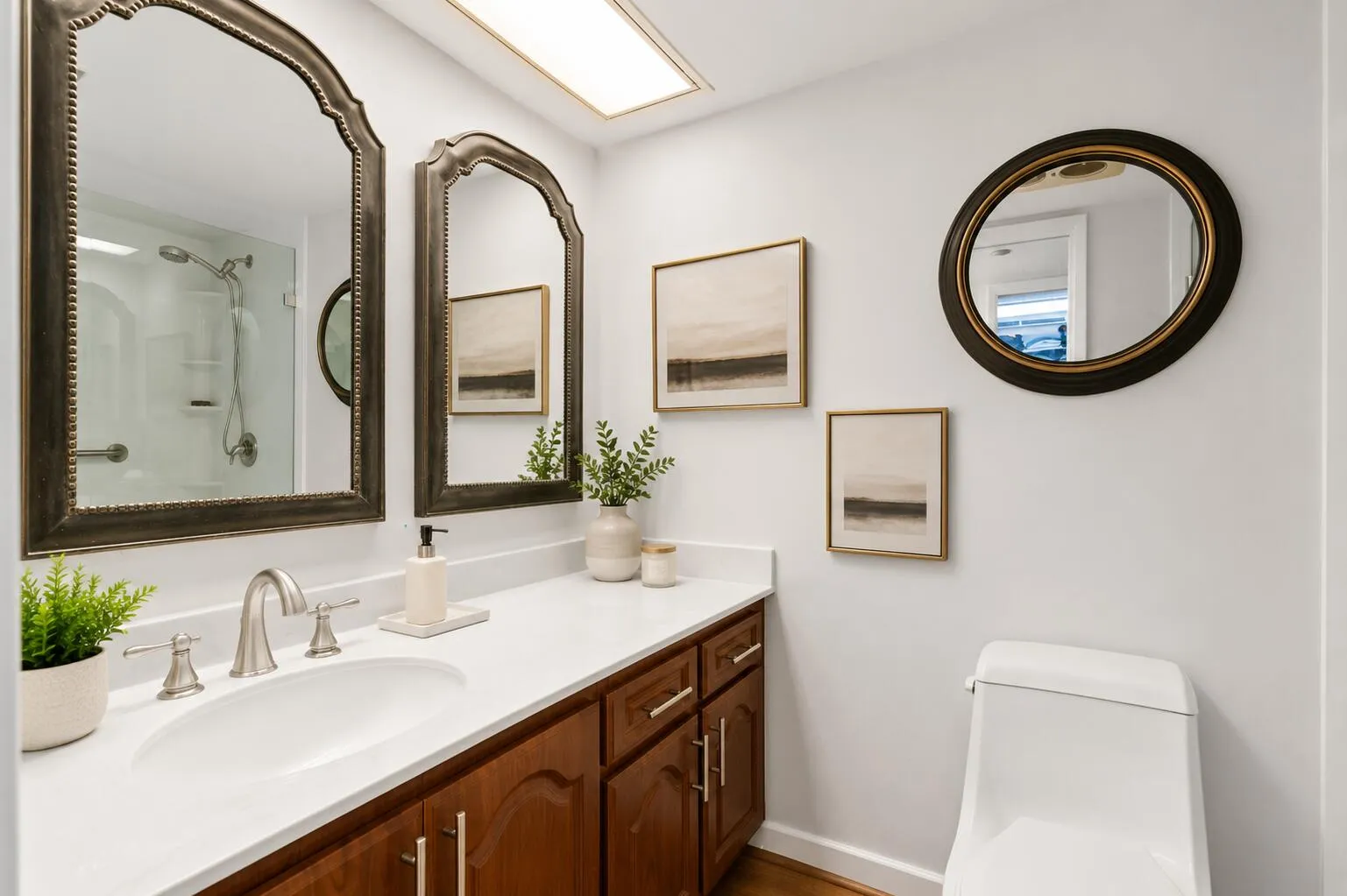 The ensuite bath features a sleek modern frameless glass shower, blending timeless style with everyday comfort.
