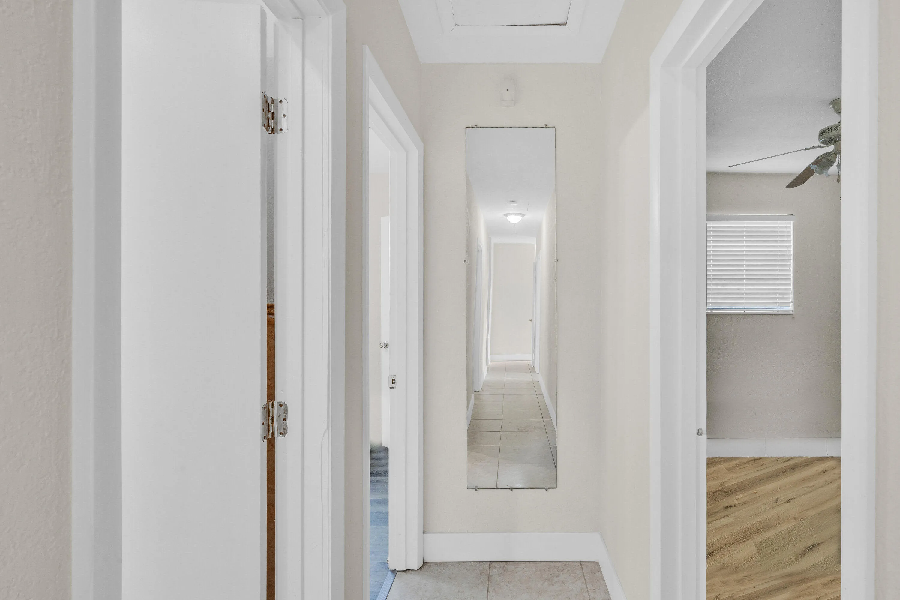 Mirror at End of Hallway and Attic Access Above